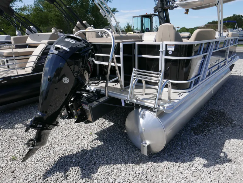 Slide: The Image of 2025 Starcraft EX Fish 20 FD pontoon boat with outboard motor on gravel. - 3