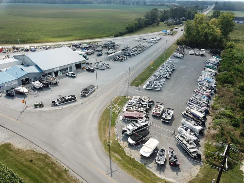 Slide: The Image of Aerial view of a boat dealership with various boats, including a 2025 Starcraft EX Fish 20 FD. - 32