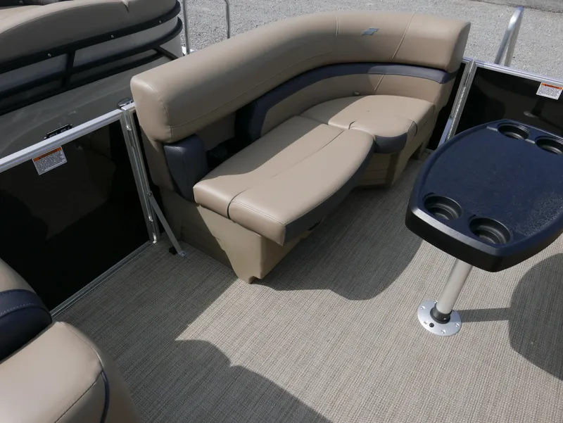 Slide: The Image of 2025 Starcraft EX Fish 20 FD boat interior with beige seating and cupholder table. - 5