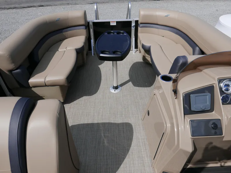 Slide: The Image of 2025 Starcraft EX Fish 20 FD boat interior with beige seating and central console. - 6