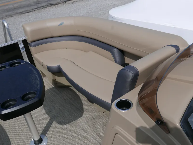 Slide: The Image of 2025 Starcraft EX Fish 20 FD boat interior with beige seating and cup holders. - 7