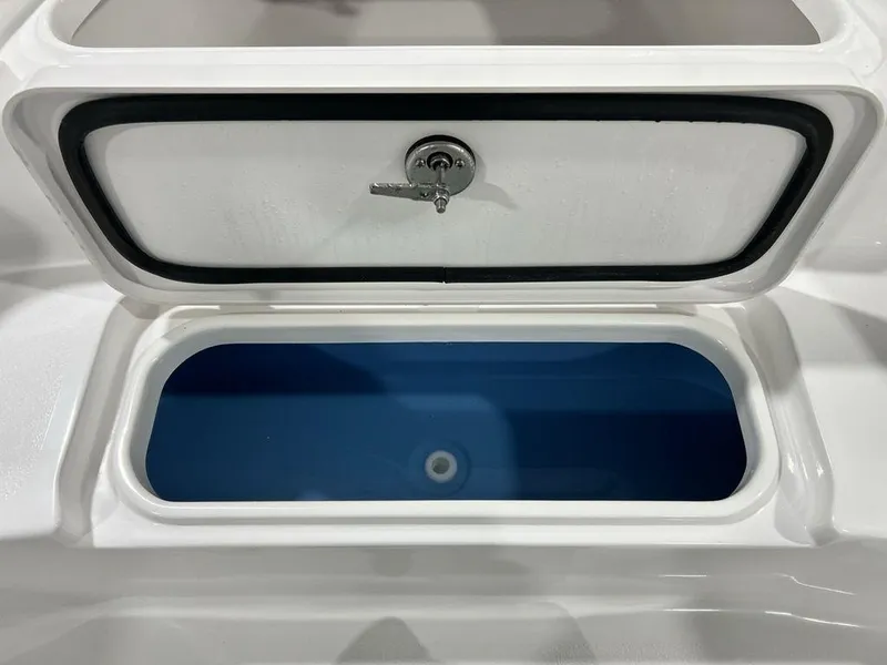 Slide: The Image of 2025 Tidewater 2110 Bay Max boat storage compartment with secure lock and blue interior. - 10