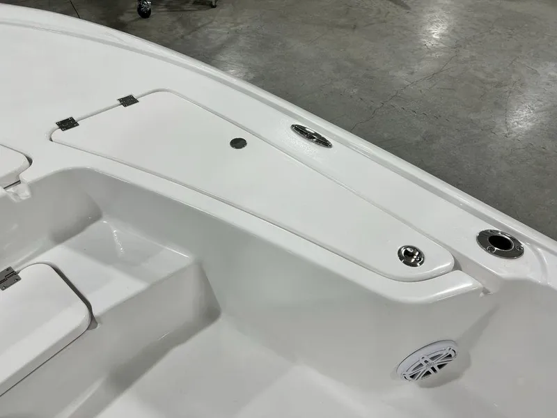 Slide: The Image of 2025 Tidewater 2110 Bay Max boat interior with storage compartment and speaker. - 11