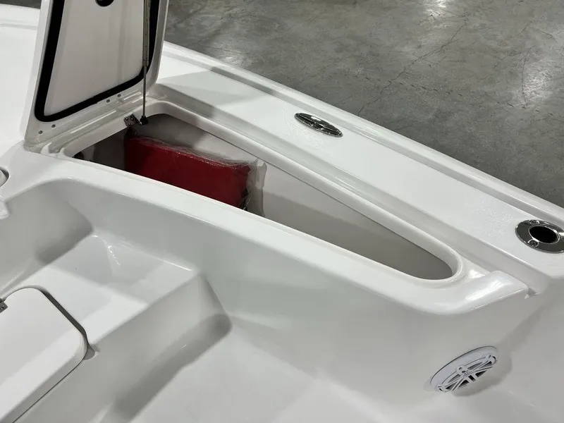 Slide: The Image of 2025 Tidewater 2110 Bay Max boat storage compartment with open hatch and visible red cushion. - 12