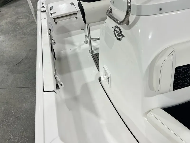 Slide: The Image of 2025 Tidewater 2110 Bay Max boat interior, showcasing sleek white design and seating. - 14