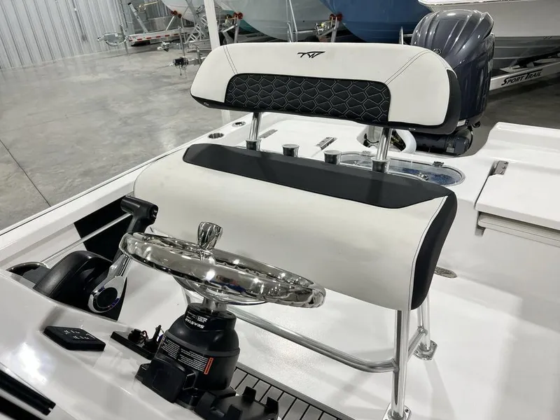 Slide: The Image of 2025 Tidewater 2110 Bay Max boat helm with steering wheel and cushioned seat. - 17