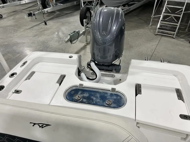 Slide: The Image of 2025 Tidewater 2110 Bay Max boat with motor in a showroom. - 21