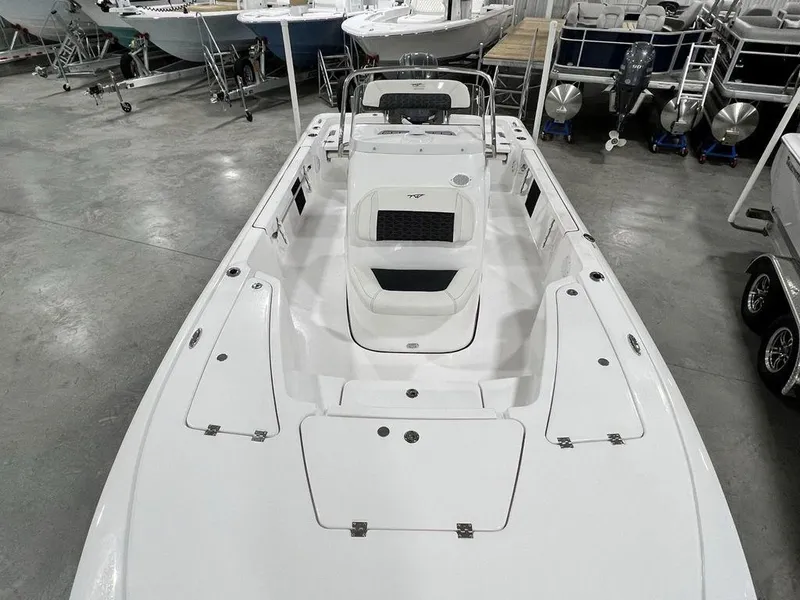 Slide: The Image of 2025 Tidewater 2110 Bay Max boat in showroom, showcasing spacious deck and seating. - 26
