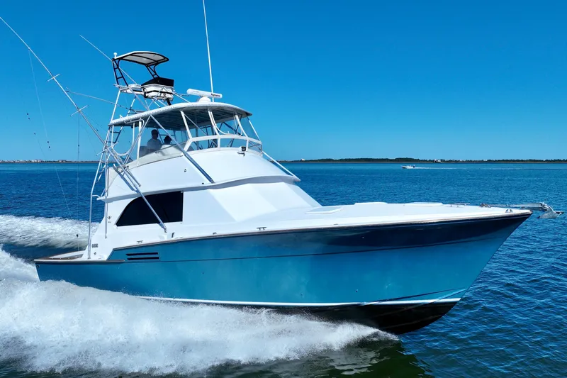 Slide: The Image of 1982 Bertram 46 Convertible yacht cruising on open water. - 0