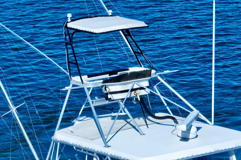 Slide: The Image of 1982 Bertram 46 Convertible boat tower against blue ocean water. - 10