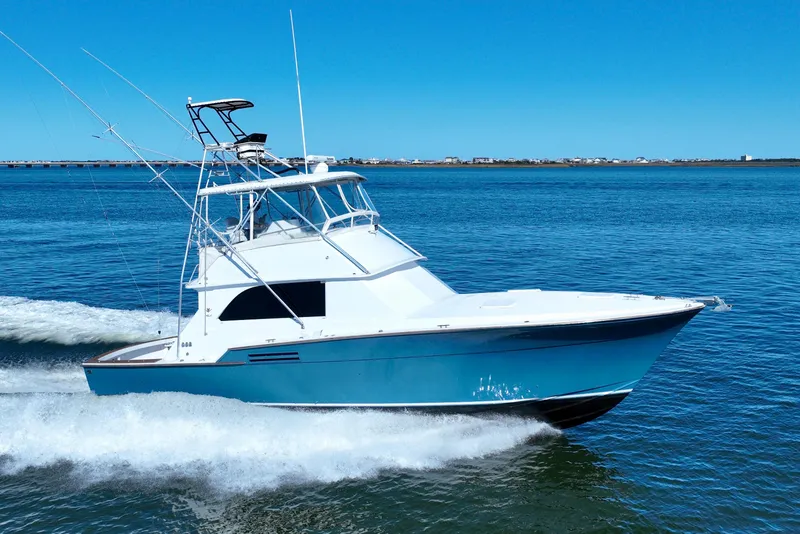 Slide: The Image of 1982 Bertram 46 Convertible yacht cruising on open water. - 13