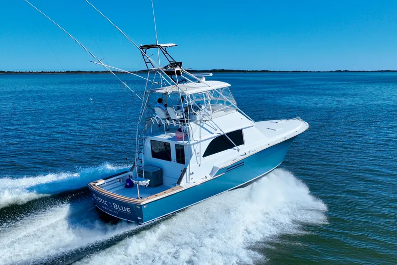 Slide: The Image of 1982 Bertram 46 Convertible yacht cruising on open water. - 16