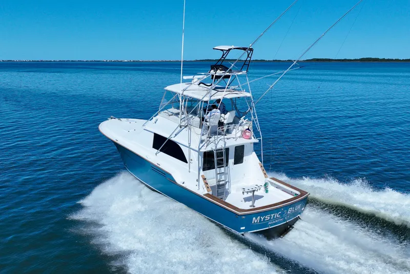 Slide: The Image of 1982 Bertram 46 Convertible yacht cruising on open water. - 17