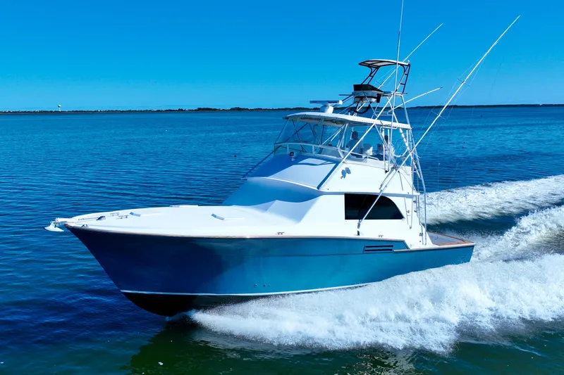 Slide: The Image of 1982 Bertram 46 Convertible yacht cruising on open water. - 19