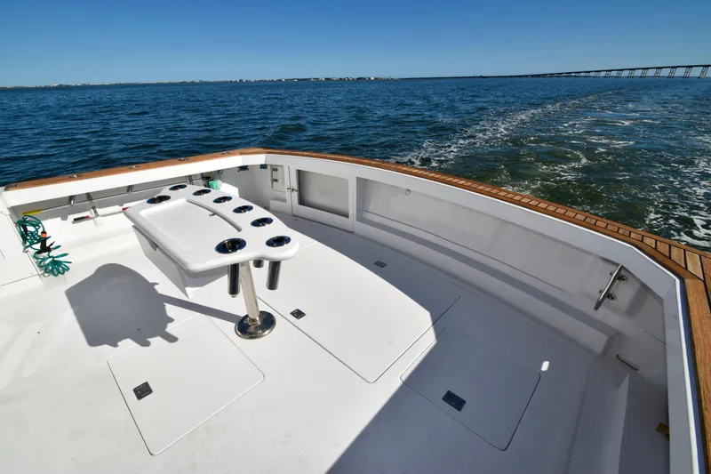 Slide: The Image of 1982 Bertram 46 Convertible boat deck with ocean view and fishing setup. - 22