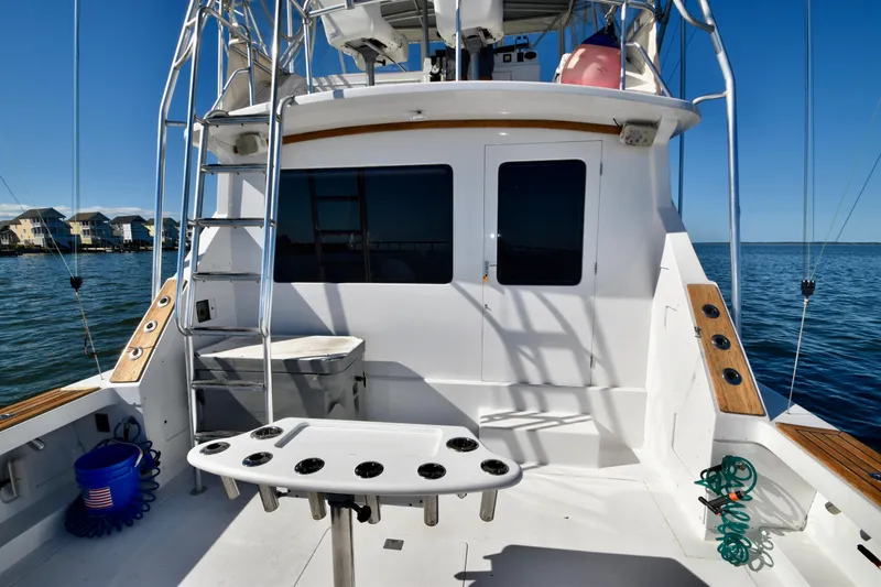 Slide: The Image of 1982 Bertram 46 Convertible fishing boat deck with ladder and ocean view. - 24