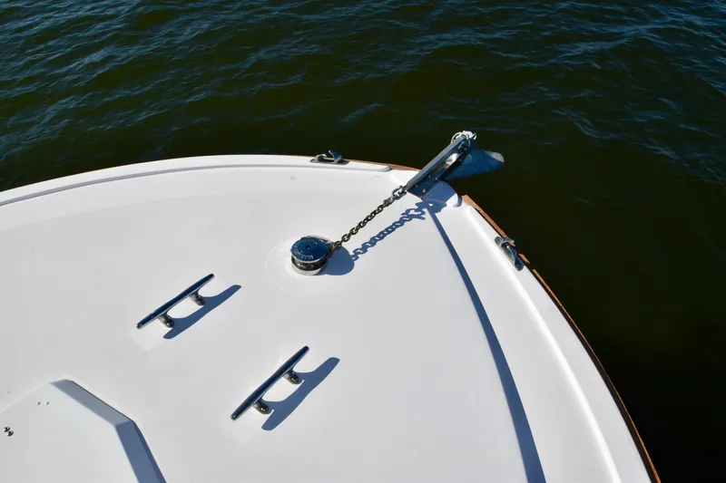 Slide: The Image of Bow of 1982 Bertram 46 Convertible yacht with anchor and cleats on calm water. - 30