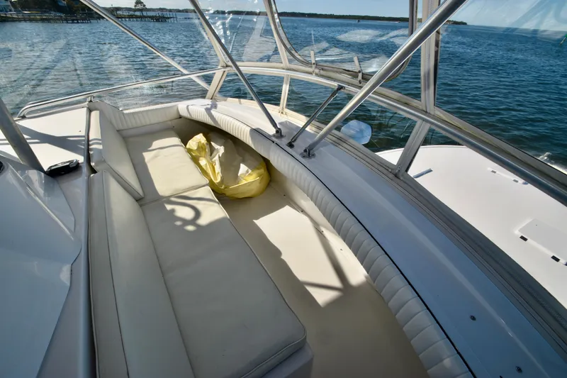 Slide: The Image of 1982 Bertram 46 Convertible boat interior with cushioned seating and ocean view. - 39