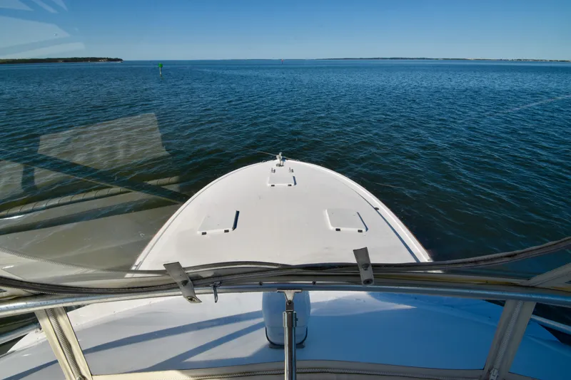Slide: The Image of Bertram 46 Convertible 1982 yacht cruising on open water, clear blue sky. - 40