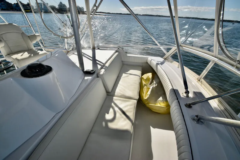 Slide: The Image of Interior view of 1982 Bertram 46 Convertible yacht with seating and water backdrop. - 41