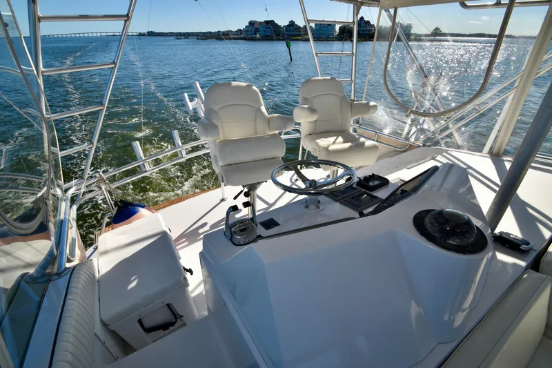 Slide: The Image of Helm of 1982 Bertram 46 Convertible yacht with ocean view and captain's chairs. - 42
