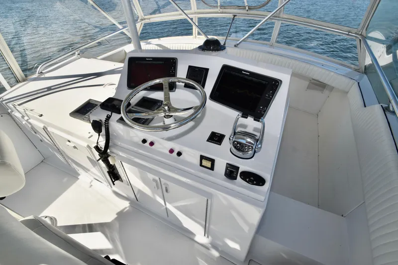 Slide: The Image of 1982 Bertram 46 Convertible helm with modern navigation equipment and steering wheel. - 45