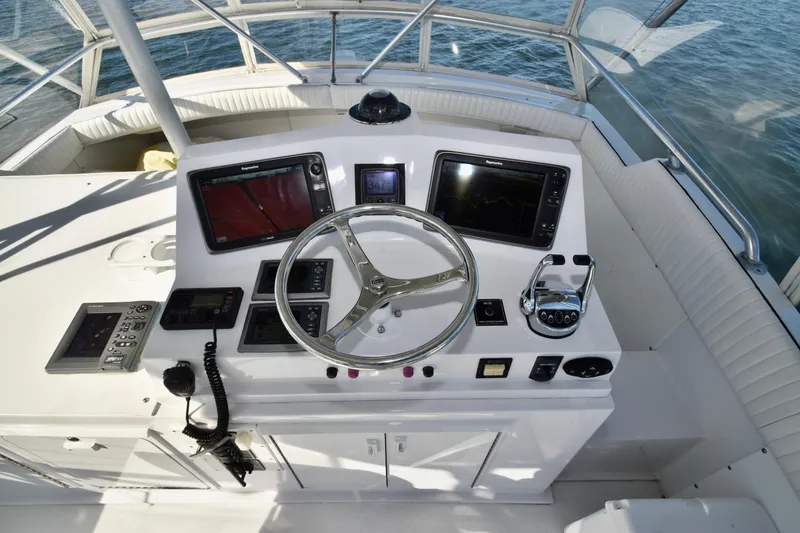 Slide: The Image of Helm of 1982 Bertram 46 Convertible with navigation equipment and steering wheel. - 46