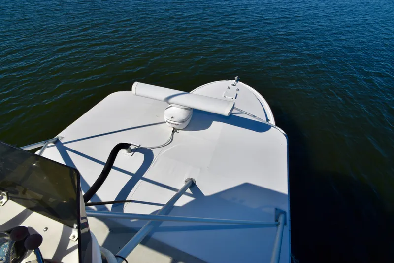 Slide: The Image of 1982 Bertram 46 Convertible boat deck on calm water. - 49