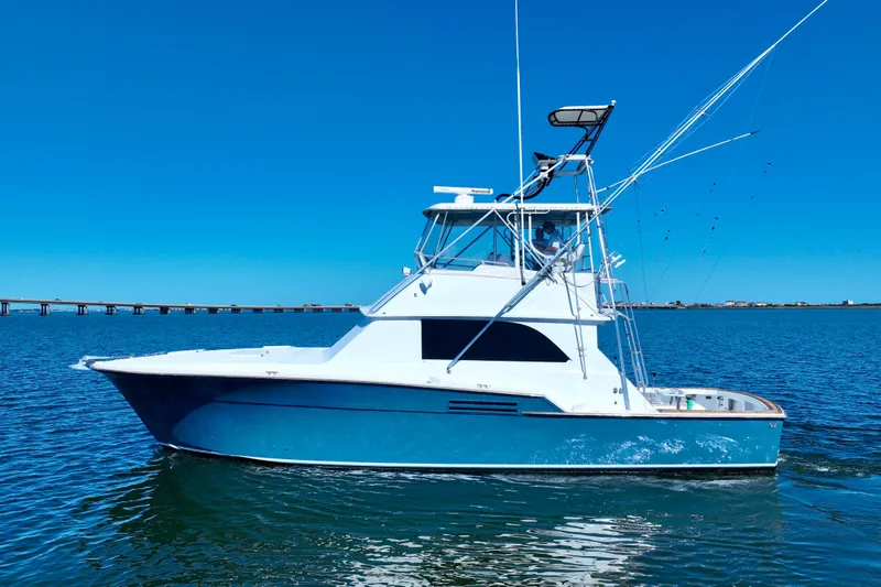 Slide: The Image of 1982 Bertram 46 Convertible yacht on calm blue water. - 6