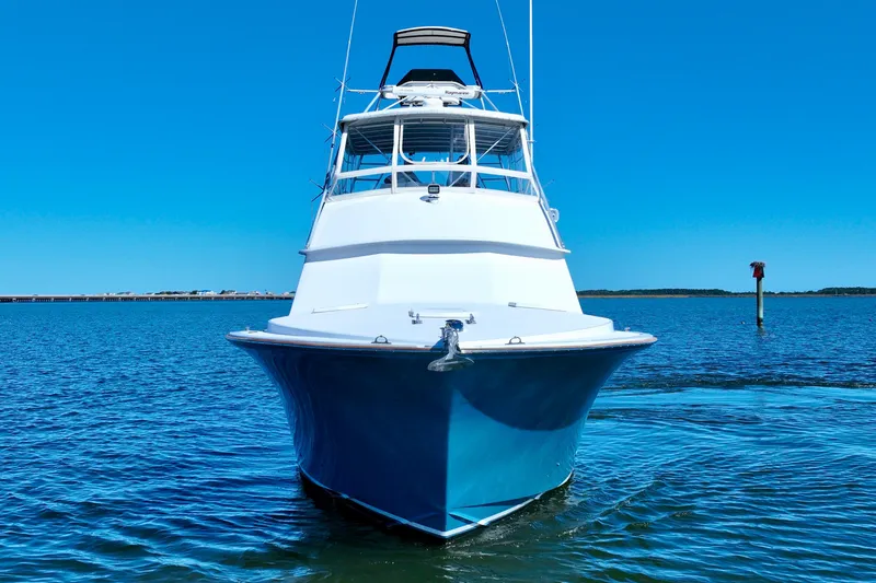 Slide: The Image of 1982 Bertram 46 Convertible yacht on calm blue water. - 8