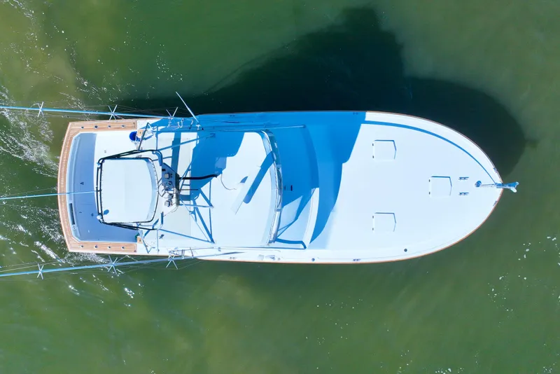 Slide: The Image of Aerial view of 1982 Bertram 46 Convertible yacht on calm water. - 9