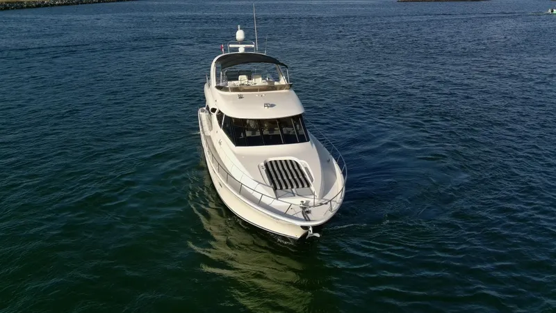 Slide: The Image of 2004 Meridian 580 Pilothouse yacht cruising on open water. - 15