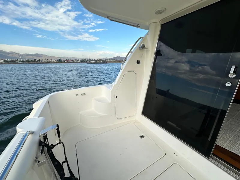 Slide: The Image of 2004 Meridian 580 Pilothouse yacht deck with ocean view and sleek design. - 20