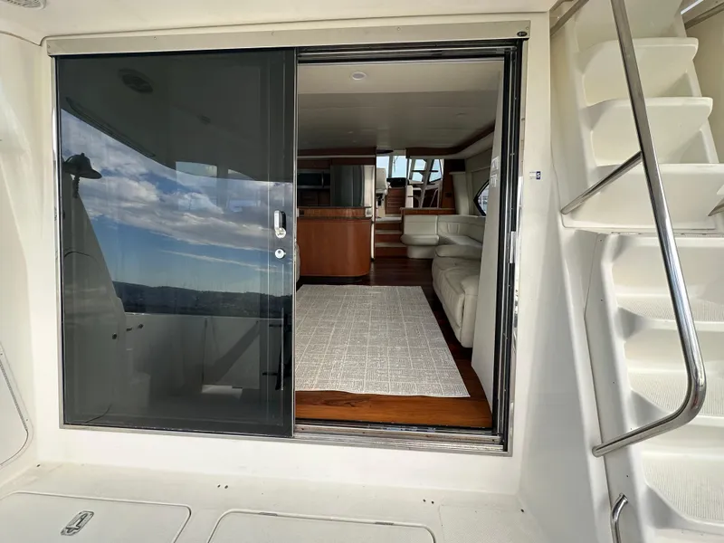 Slide: The Image of 2004 Meridian 580 Pilothouse yacht interior with sliding glass door and staircase. - 22