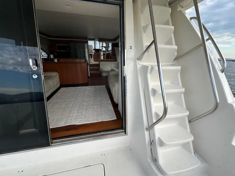Slide: The Image of 2004 Meridian 580 Pilothouse interior with stairs and modern furnishings. - 23