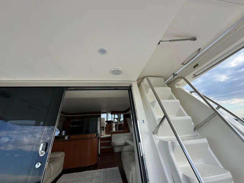 Slide: The Image of Meridian 580 Pilothouse 2004 yacht interior with stairs and seating area. - 25