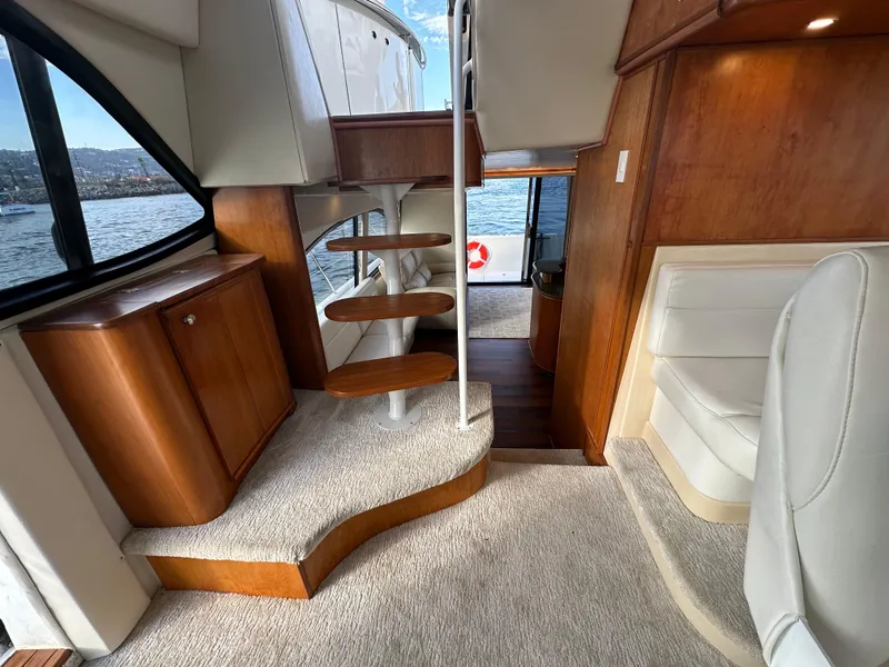 Slide: The Image of Interior of 2004 Meridian 580 Pilothouse yacht with wooden stairs and plush seating. - 45