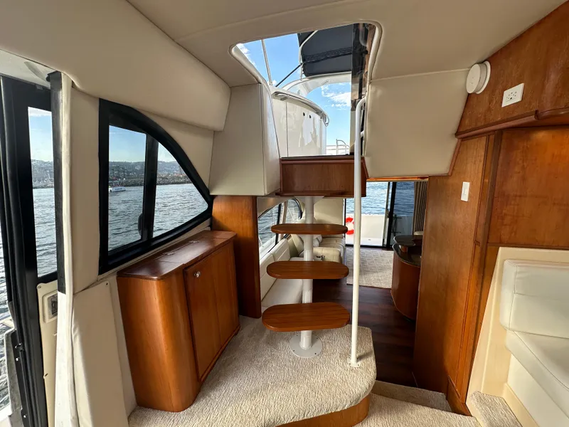 Slide: The Image of Interior of 2004 Meridian 580 Pilothouse yacht with wooden stairs and scenic window view. - 46