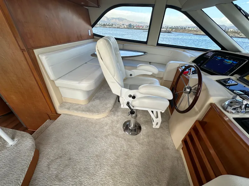 Slide: The Image of Luxurious 2004 Meridian 580 Pilothouse interior with helm, seating, and panoramic windows. - 48
