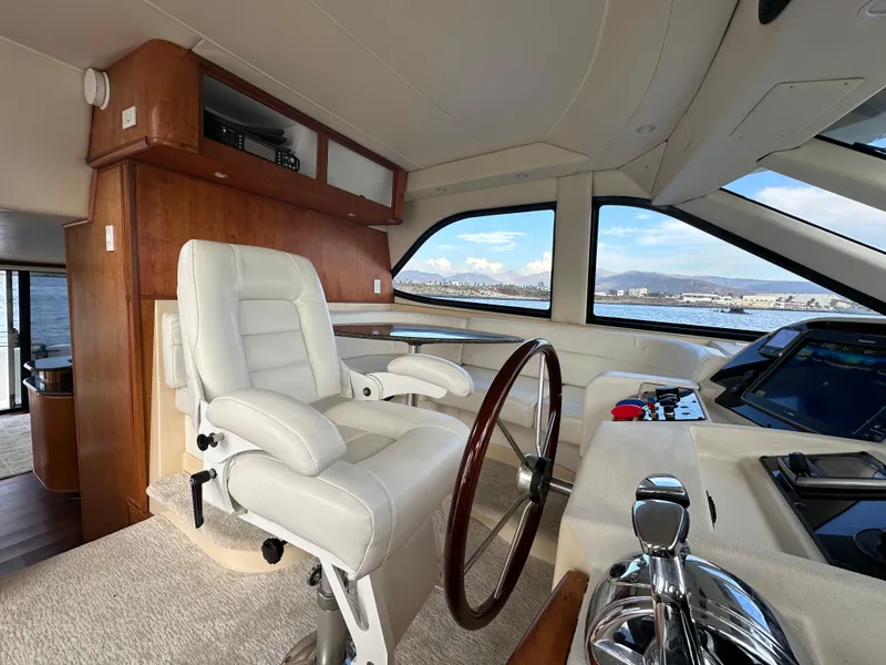 Slide: The Image of 2004 Meridian 580 Pilothouse interior with captain's chair and navigation controls. - 49