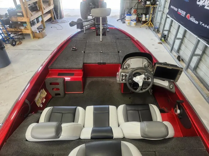Slide: The Image of 2013 Skeeter TZX 190 boat interior with steering console and seating, in a garage setting. - 5