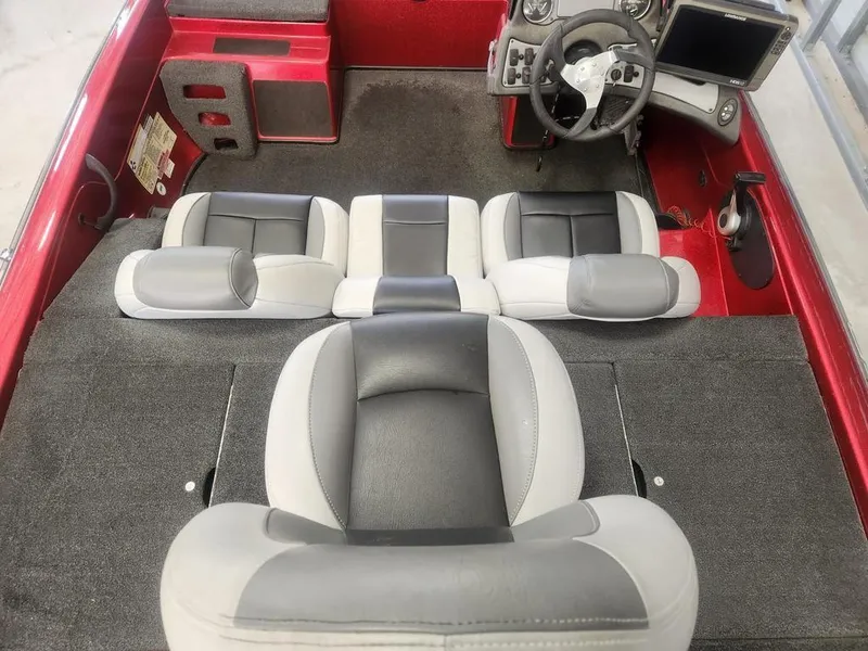 Slide: The Image of 2013 Skeeter TZX 190 boat interior with gray and black seating, red accents, and steering console. - 6
