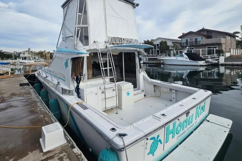 Slide: The Image of 1988 Trojan 12 Meter Convertible yacht cruising on open sea under clear blue sky. - 2