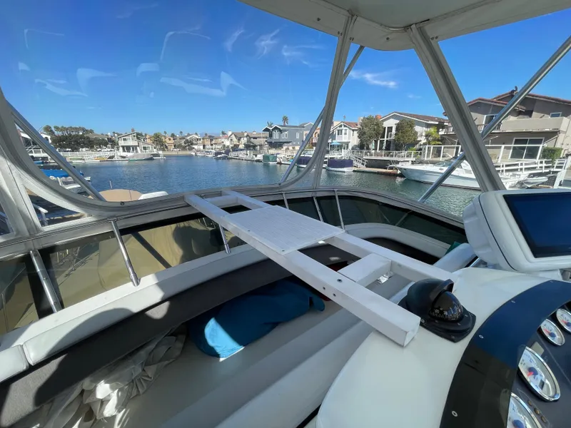 Slide: The Image of 1988 Trojan 12 Meter Convertible boat interior with cushioned seating and storage. - 25