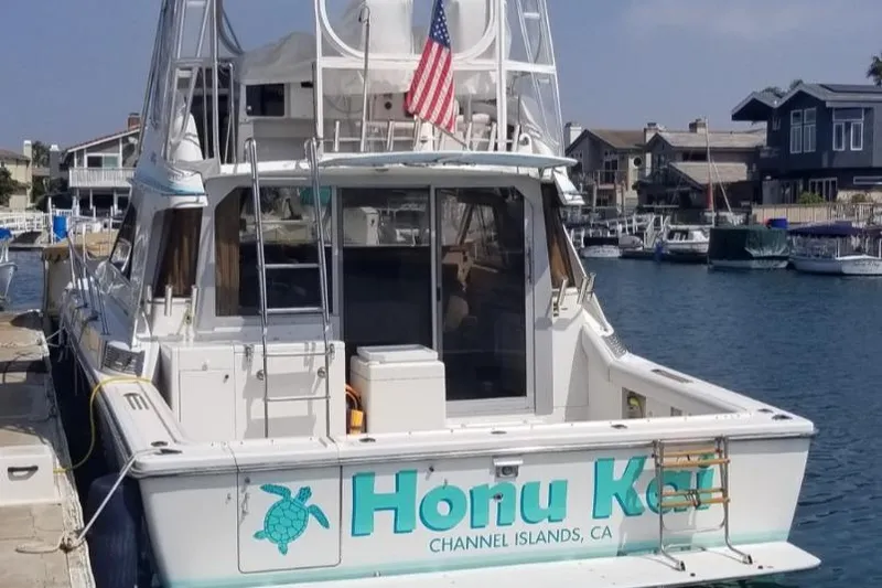 Slide: The Image of 1988 Trojan 12 Meter Convertible yacht on open sea under clear blue sky. - 3