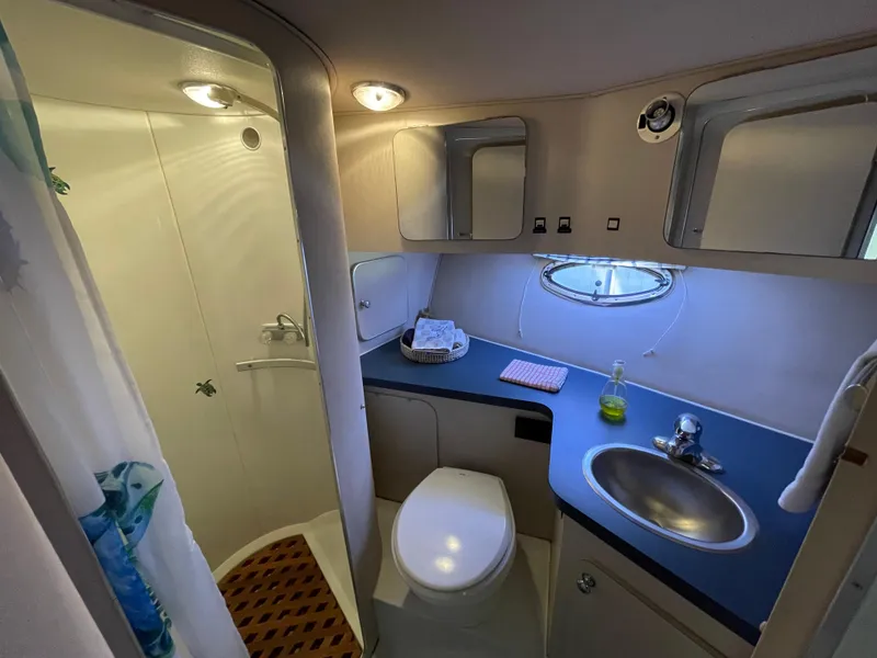 Slide: The Image of Cozy 1988 Trojan 12 Meter Convertible cabin with fish-themed bedding and porthole windows. - 50