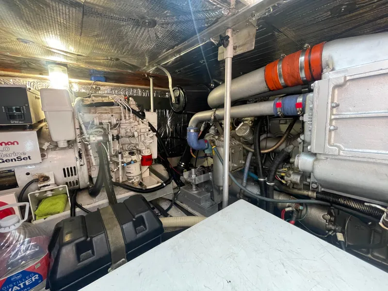 Slide: The Image of 1988 Trojan 12 Meter Convertible yacht bathroom with shower, sink, and porthole window. - 54