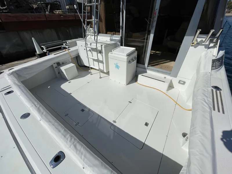 Slide: The Image of 1988 Trojan 12 Meter Convertible yacht on calm water, scenic background. - 7