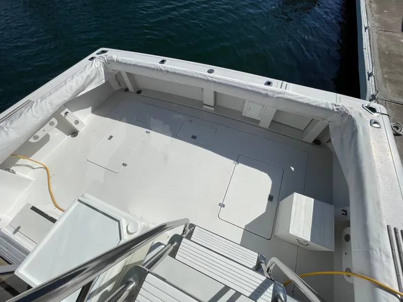 Slide: The Image of 1988 Trojan 12 Meter Convertible yacht anchored near rocky shoreline. - 8