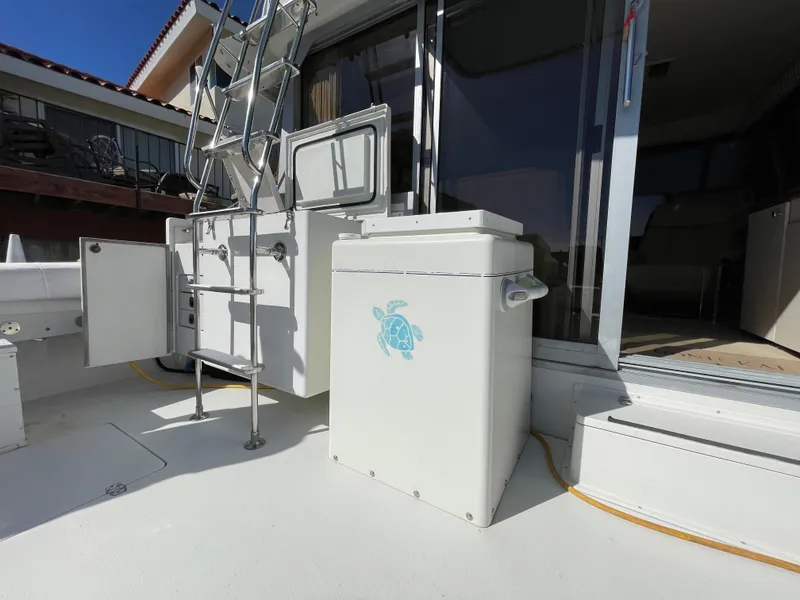 Slide: The Image of 1988 Trojan 12 Meter Convertible boat deck with storage and seating. - 11